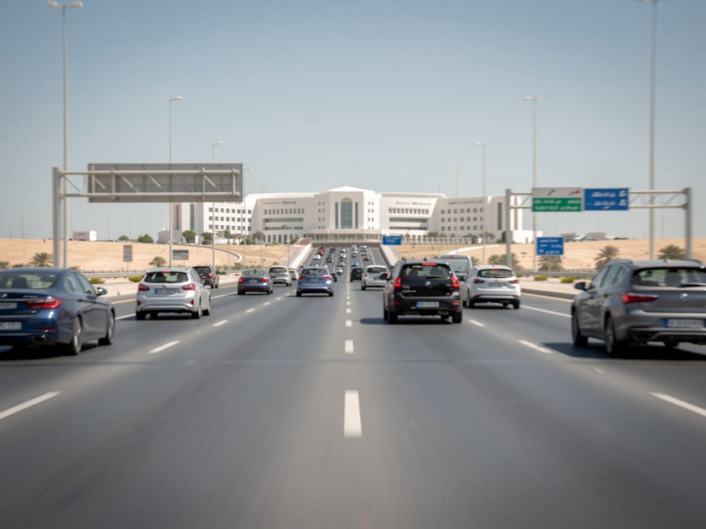 Modern road approaching central Abu Dhabi and distant white civic architecture